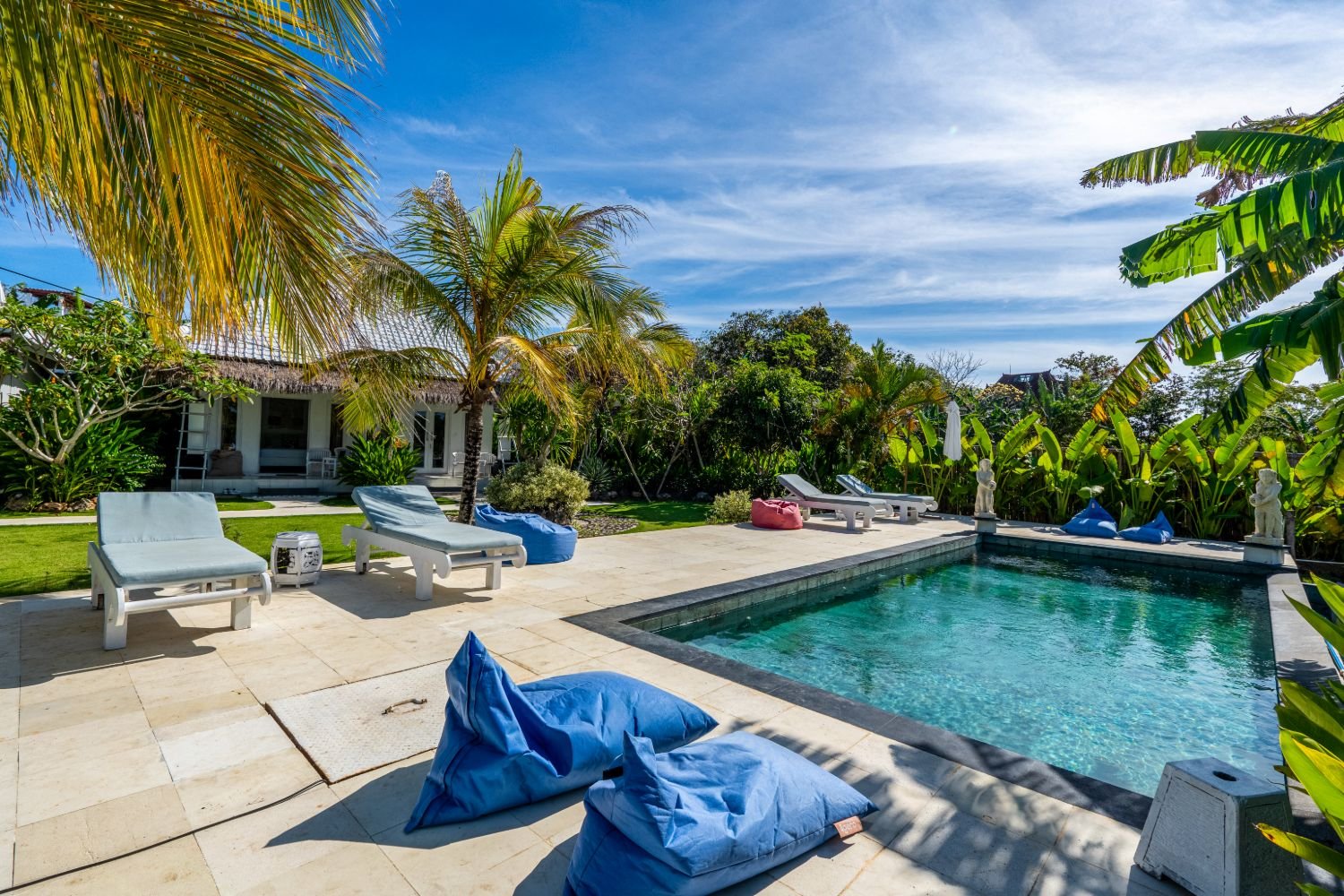 Pool and sun loungers under blue sky